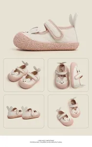 Detailed views of cute pink and white rabbit-themed soft leather first walking baby shoes.