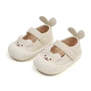 Cute beige toddler walking shoes with cartoon rabbit ears and soft leather finish.