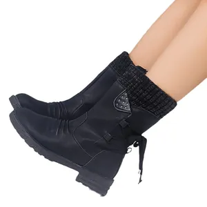 Women's black mid-calf Martin boots with knitted collar and rear bow detail, side view