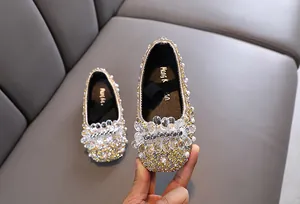 Primo piano dei dettagli in strass e perle scintillanti sulle scarpe da danza per bambina
