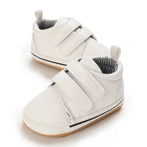 Classic white baby walking shoes with velcro straps and non-slip rubber soles.