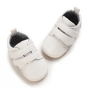 Top view of white baby boy pre-walker shoes with double velcro straps and rubber sole