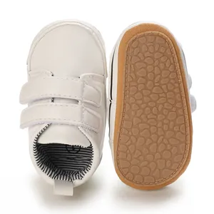 Detailed view of white baby boy toddler shoes with non-slip sole and Velcro straps