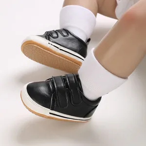 Close-up of black baby boy walking shoes with anti-slip rubber soles and velcro straps