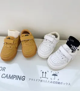 Close-up detail view of yellow and white casual toddler walking sneakers for kids