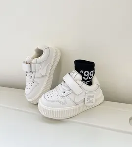 Close-up detail of white toddler board shoes with soft sole and convenient Velcro straps