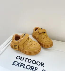 Mustard yellow soft-soled toddler sneakers with velcro closure for boys and girls