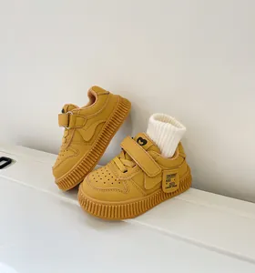 Close-up of stylish yellow toddler sneakers featuring Velcro straps and soft non-slip soles
