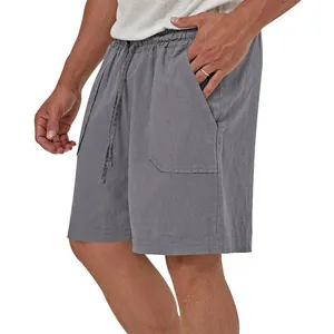 Detail view of men's grey cotton linen shorts showing side pocket and drawstring waist.