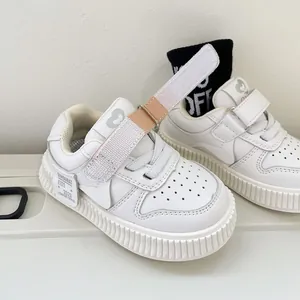 White toddler board shoes with soft soles and adjustable velcro straps for baby boys and girls