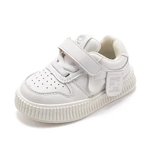 White toddler walking shoes with soft soles and adjustable velcro straps for boys and girls