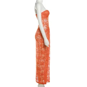 Side view detail showing the intricate floral lace texture of the orange bodycon dress.