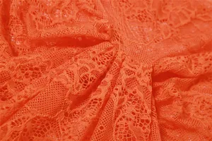 Close-up of orange floral lace fabric on a sheer sexy bodycon dress