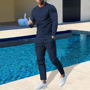 Detailed view of men's navy blue long-sleeve tracksuit set worn by model outdoors