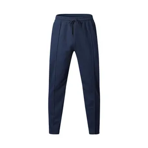 Detailed view of navy blue sports pants featuring a drawstring waist and vertical seam lines.