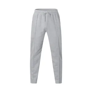 Detail view of light grey men's joggers with elastic drawstring waist and decorative front pleat