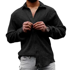 Detail view of men's black long sleeve shirt with crinkled texture and buttoned front