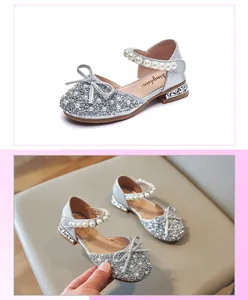 Close-up of sparkling silver girls princess sandals featuring pearls and bow detailing