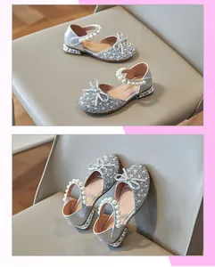 Detail view of silver girl princess sandals with pearls, bow, and sparkling rhinestones.