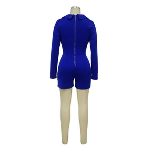 Back view of long-sleeved blue romper jumpsuit with zipper closure on mannequin.