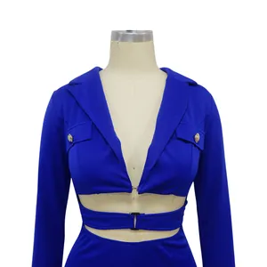 Detailed view of blue deep V-neck jumpsuit with decorative pockets and gold buttons