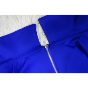 Detailed macro view of the silver metal zipper on a stylish royal blue v-neck jumpsuit
