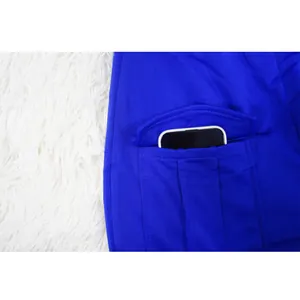 Close-up detail of a functional side pocket on a vibrant blue jumpsuit for women
