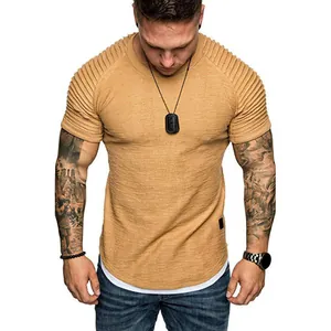 Detailed view of men's textured short sleeve T-shirt with pleated shoulders and curved hem