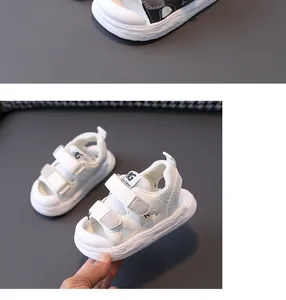 Detailed view of white non-slip soft-soled baby sandals with mesh and velcro straps