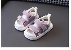 Close-up of purple baby sandals with dual Velcro straps and white non-slip rubber soles