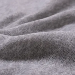 Macro shot of soft grey thermal fabric texture for men's winter base layer shirt.