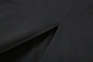 Close-up macro view showing the high-quality stitching and slit detail on a black dress.