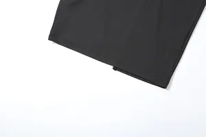 Detailed macro view of a black slim fit hooded dress hem showing stitching and back slit