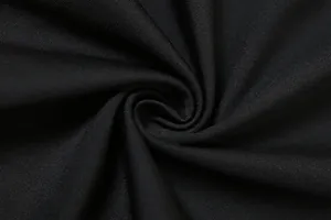 Macro detail of high-quality black elastic knitted fabric for fashion women's dress.