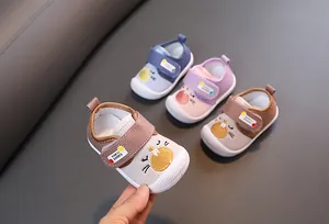 Macro detail of toddler squeaky walking shoes featuring cartoon cat designs in various colors