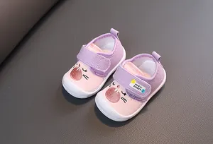 Close-up of cute purple cartoon cat baby squeaky shoes with velcro strap