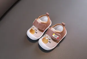Detail of cartoon squeaky baby walking shoes with breathable fabric and velcro straps
