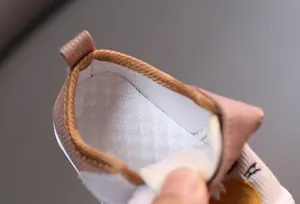 Detailed macro view of the breathable and soft interior lining of cartoon baby shoes