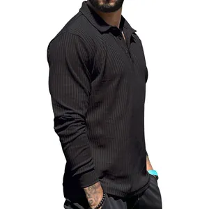 Close-up of men's black long-sleeve ribbed polo shirt showing texture and slim fit.