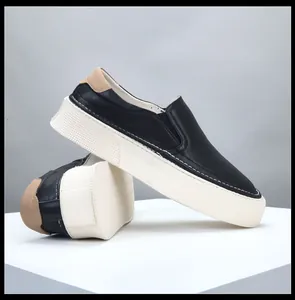 Side view of men's black leather slip-on loafers with thick white platform soles
