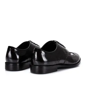 Vue arrière détaillée de chaussures richelieu en cuir noir avec perforations bout aile