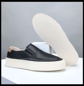 Macro view of men's black leather platform loafers showing sole and upper details.
