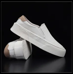 Close-up of white soft leather men's slip-on loafers with thick textured sole