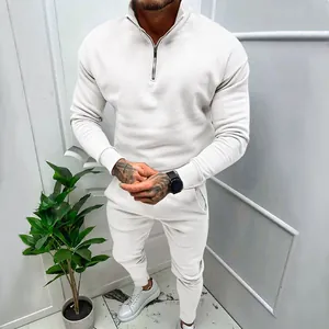 Detail view of a men's fleece-lined solid color tracksuit set with a half-zip top