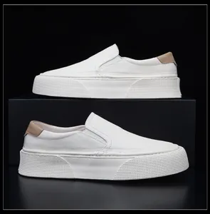 Side view of white soft leather slip-on loafers with thick platform soles on black display