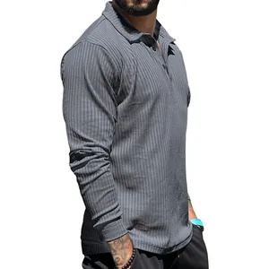 Close-up of men's gray long-sleeve ribbed polo shirt with textured fabric details.