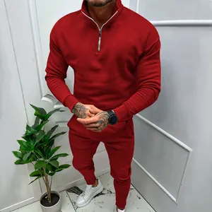 Detailed view of a men's red fleece-lined athletic tracksuit with a stylish quarter-zip top