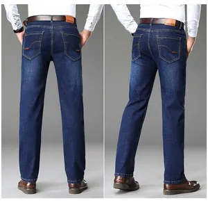 Back view of classic dark blue straight-leg men's jeans in a professional studio setting.