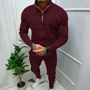 Close-up of burgundy men's fleece tracksuit with quarter-zip neck and ribbed cuffs