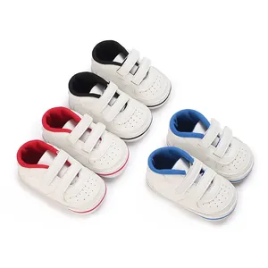 Collection of white infant walking shoes with colorful lining and velcro straps.